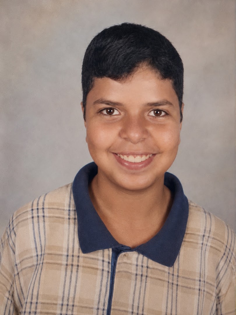 Ahmed in a later childhood portrait, smiling with his teeth visible